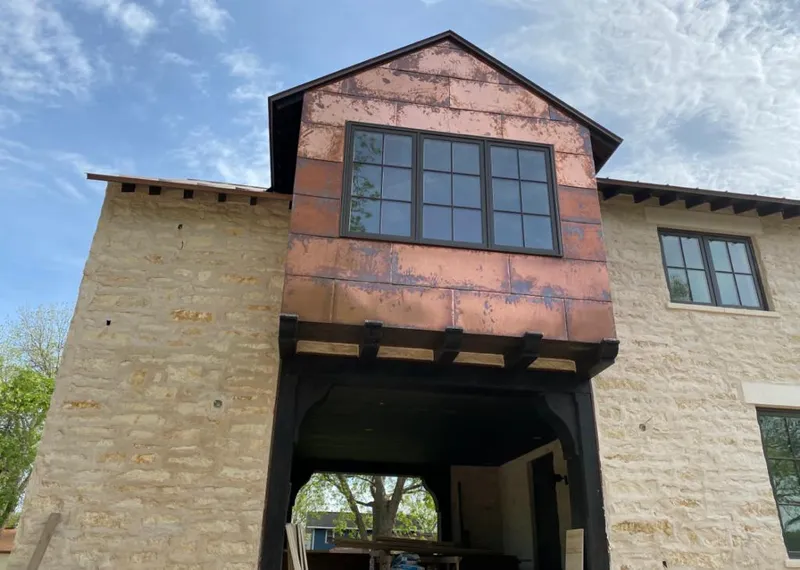 Copper metal panel facade on a stone building for Skylight Installation in Dumas
